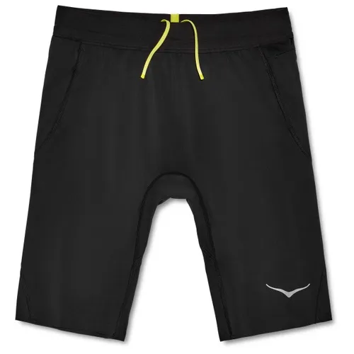 Hoka Herren Novafly Half Tight schwarz - Laufbekleidung mit optimalem Halt und praktischen Taschen für Smartphone und Schlüssel, ideal für sportliche Aktivitäten und vielseitig kombinierbar.