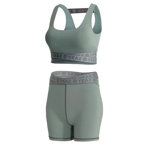 YEAZ Set REVOLUTE - Stylisches Sportbekleidungs-Set, das mit einem coolen Top und High Waist Shorts überzeugt. Ideal für Workouts und Freizeit, bietet es perfekten Halt und Support dank der gekreuzten Bänder im YEAZ-Design.