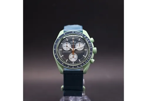 Swatch Chronograph OMEGA x Swatch MoonSwatch Mission on Earth - Elegante Armbanduhr mit Bioceramic Gehäuse und hochwertigem Straußenlederarmband. Das harmonische Design in erdigen Grüntönen und Blau kombiniert ikonische Elemente der Speedmaster mit modernem Stil.