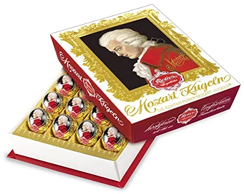 Reber Mozart-Kugeln Barock, 20er Packung, Zartbitter-Schokolade - Genießen Sie Reber Mozart-Kugeln Barock in der 20er Packung! Gefüllt mit feinem Pistazien-Marzipan und Haselnuss-Nougat, bieten diese hochfeinen Pralinen ein unvergessliches Geschmackserlebnis. Ideal für besondere Anlässe!
