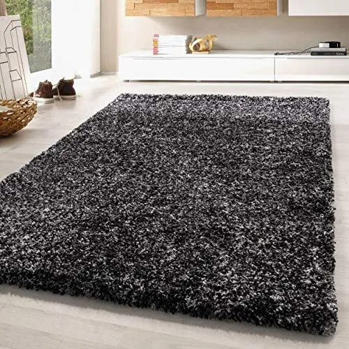 SIMPEX Hochflor Teppich Anthrazit 140 x 200 cm - Pflegeleicht und Extra Flauschig für Wohnzimmer und Schlafzimmer - Attraktives meliertes Design: Dieser Hochflor-Teppich bringt mit seiner zeitlosen Ästhetik und der weichen Oberfläche Gemütlichkeit in Ihr Zuhause. Hergestellt aus strapazierfähigem Polypropylen, ist er ideal für vielgenutzte Räume.