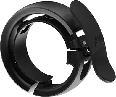 Knog Oi Prima Large Fahrradklingel - Fahrradklingel für Lenkerdurchmesser 23.8 - 31.8mm, elegantes Design in Anthrazit, ideal für stilbewusste Radfahrer.