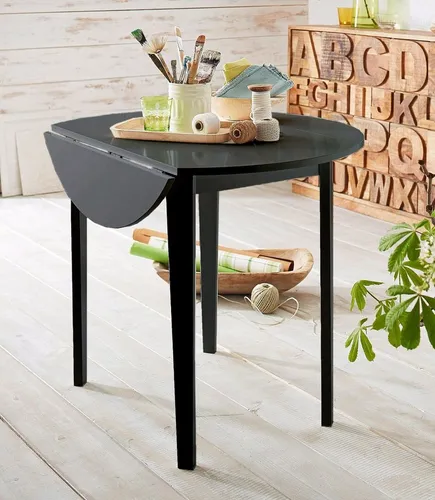 Esstisch mit abklappbaren Seitenteilen - Schwarz - Moderner Esstisch aus MDF und massivem Hevea-Holz, ideal für kleine Räume. Mit 2 abklappbaren Seitenteilen für flexible Nutzung. Höhe 77 cm, Durchmesser 92 cm im ausgeklappten Zustand.