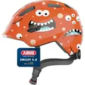ABUS Kinderhelm Smiley 3.0 - Fahrradhelm mit tiefer Passform, kindergerechten Designs & Platz für einen Zopf - für Mädchen und Jungs - Orange mit Monster-Muster, Größe M